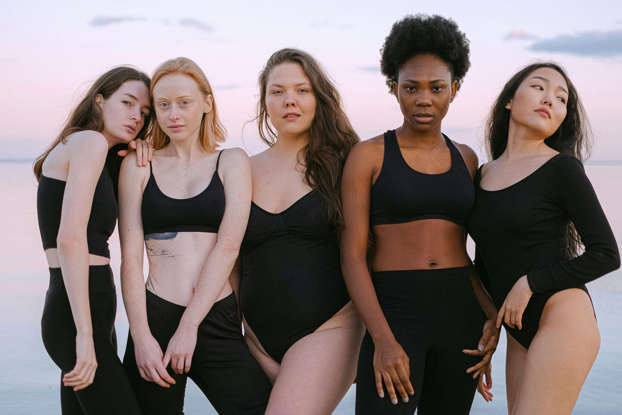 women with different body types standing together showing body shape diversity for styling guide