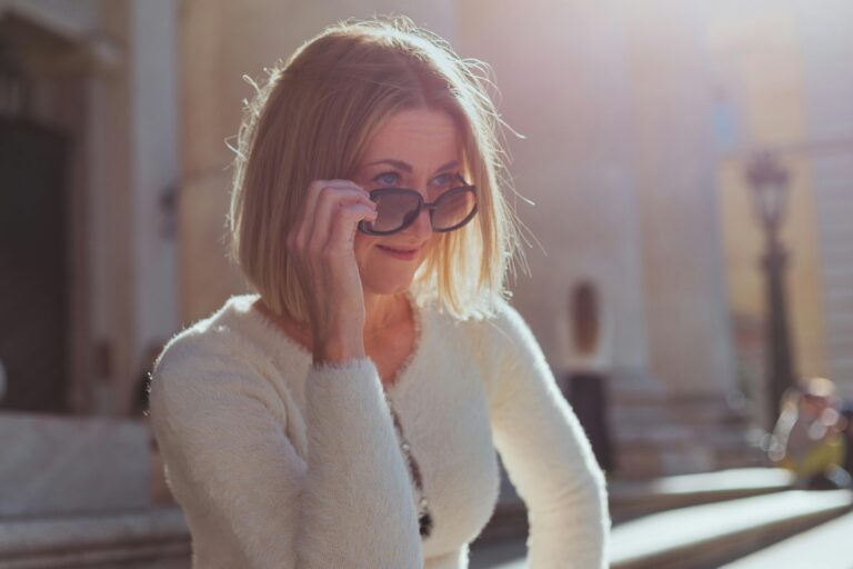 Stylish woman over 40 wearing a classy neutral outfit and sunglasses showing elegant fashion and common style mistakes to avoid in your 40s.