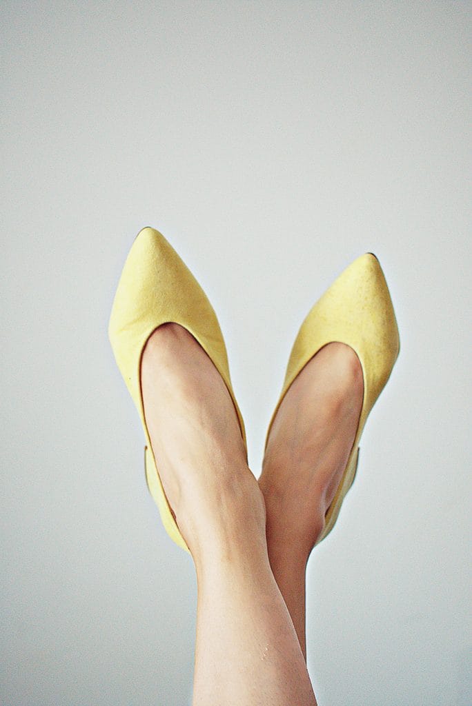 Yellow pointed-toe shoes for petite women that create a longer-looking leg line and petite women look taller.