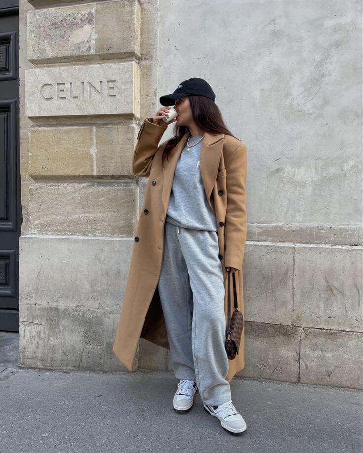 How to style a trench coat with a matching sweatshirt and sweatpants for a comfortable street style look.