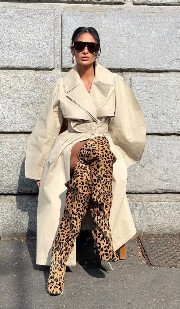 Woman wearing a cream trench coat with leopard print shoes, showing how to style cream, beige, and camel colors with animal print outfits.