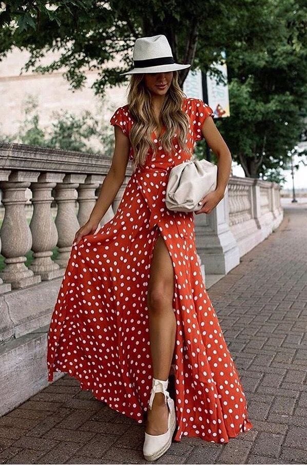 Woman wearing a red and white polka dot wrap dress with a defined waist and flowing skirt, showing a flattering wrap dress for pear-shaped body.